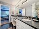 Bathroom featuring double vanity, granite counters, stylish lighting, and a walk in shower at 120 1St E St # 104, St Petersburg, FL 33715
