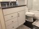 Bathroom featuring a granite countertop vanity, modern cabinetry, and tile floors at 120 1St E St # 104, St Petersburg, FL 33715