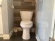 Bathroom featuring toilet with wood accent wall, offering a comfortable and well-maintained space at 120 1St E St # 104, St Petersburg, FL 33715