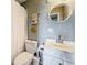 Bathroom with a decorative nautical theme including a vanity, mirror and towel rack at 120 1St E St # 104, St Petersburg, FL 33715