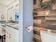Modern bathroom featuring dual granite countertops, white cabinets, a shelf with plants, and stylish fixtures at 120 1St E St # 104, St Petersburg, FL 33715
