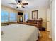 Bright bedroom with wood floors, custom headboard, ceiling fan, and decorative furniture and fixtures at 120 1St E St # 104, St Petersburg, FL 33715