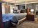 The main bedroom features a plush bed, mirrored wall and ample natural light at 120 1St E St # 104, St Petersburg, FL 33715