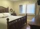 Comfortable bedroom featuring natural lighting, shutters, a hardwood floor, and decorative furnishings at 120 1St E St # 104, St Petersburg, FL 33715