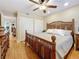 Comfortable bedroom featuring wood floors, ceiling fan, closet and decorative wood frame bed at 120 1St E St # 104, St Petersburg, FL 33715