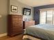 This bedroom boasts two wooden dressers, a TV, and a large window at 120 1St E St # 104, St Petersburg, FL 33715