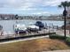 View of boat dock on the water with palm tree in the background at 120 1St E St # 104, St Petersburg, FL 33715