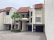This building's exterior includes a Spanish-style roof, well-kept landscaping and garage parking at 120 1St E St # 104, St Petersburg, FL 33715