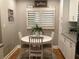 Cozy eat-in kitchen with white round table, chairs, custom shutters, and coordinated decor at 120 1St E St # 104, St Petersburg, FL 33715