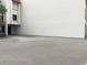 The building's exterior has a smooth stucco facade with a large, paved parking area at 120 1St E St # 104, St Petersburg, FL 33715