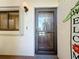 Front door with a storm door, adjacent to a small window at 120 1St E St # 104, St Petersburg, FL 33715