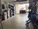Well-lit garage with epoxy flooring and a red car parked in front at 120 1St E St # 104, St Petersburg, FL 33715