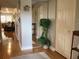 Hallway with hardwood floors, mirrored wall and a view of the living room at 120 1St E St # 104, St Petersburg, FL 33715