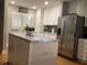 Well-lit eat-in kitchen boasts stainless appliances, a center island, and custom decor at 120 1St E St # 104, St Petersburg, FL 33715
