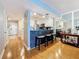 Open-concept area with a breakfast bar with stools, wood floors, and white cabinets at 120 1St E St # 104, St Petersburg, FL 33715