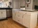Kitchen island with white cabinets, stainless steel countertop, and hardwood flooring at 120 1St E St # 104, St Petersburg, FL 33715
