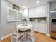 Eat-in kitchen area with white table, four chairs, and window shutters for natural light at 120 1St E St # 104, St Petersburg, FL 33715
