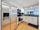 Bright kitchen with stainless steel appliances, white cabinets, and granite countertops at 120 1St E St # 104, St Petersburg, FL 33715