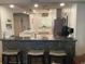 Stylish kitchen features a breakfast bar with seating, stainless steel appliances, and modern white cabinetry at 120 1St E St # 104, St Petersburg, FL 33715