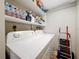 Clean laundry area with shelves, a washing machine and dryer, storage space, and cleaning supplies at 120 1St E St # 104, St Petersburg, FL 33715