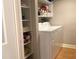 This laundry room features white walls, shelving and a white washing machine and dryer at 120 1St E St # 104, St Petersburg, FL 33715