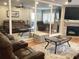 Inviting living room with a stacked stone fireplace, neutral color palette, and comfortable, mirrored wall at 120 1St E St # 104, St Petersburg, FL 33715