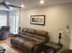 Comfortable living room featuring leather seating, decorative lamps, hardwood floors and plantation shutters at 120 1St E St # 104, St Petersburg, FL 33715