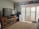 Living room featuring a wooden entertainment center, white shutter doors, and neutral colored carpet at 120 1St E St # 104, St Petersburg, FL 33715