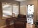 Cozy living room with shutters, slider to outdoor patio, and recliner chair at 120 1St E St # 104, St Petersburg, FL 33715