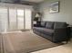 Cozy living room with a comfortable sofa and plantation shutters, creating a relaxing and inviting space at 120 1St E St # 104, St Petersburg, FL 33715