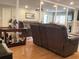 Open-concept living room featuring leather furniture, a wet bar and a mirrored accent wall at 120 1St E St # 104, St Petersburg, FL 33715