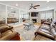 Spacious living room with a ceiling fan, a large mirror wall, a stone fireplace, and comfortable leather furniture at 120 1St E St # 104, St Petersburg, FL 33715
