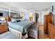 Bright and airy main bedroom featuring a king-sized bed, wooden furniture, closet and bath access, and soft carpet at 120 1St E St # 104, St Petersburg, FL 33715