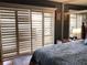 The main bedroom features a large window with shutters and a mirrored headboard at 120 1St E St # 104, St Petersburg, FL 33715