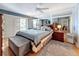 Spacious main bedroom featuring a queen-sized bed, wood furniture, a ceiling fan, and access to the balcony at 120 1St E St # 104, St Petersburg, FL 33715