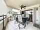 Cozy tiled patio with four cushioned chairs, table, ceiling fan and condo view at 120 1St E St # 104, St Petersburg, FL 33715