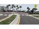 A well-maintained street with a bicycle lane, pedestrian crosswalk and surrounding palm trees at 120 1St E St # 104, St Petersburg, FL 33715