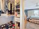Walk-in closet with storage solutions leading to a bedroom with a ceiling fan and sliding glass doors to a patio at 120 1St E St # 104, St Petersburg, FL 33715