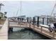 Picturesque waterfront showcasing a wooden pier with multiple boats docked and serene water views at 120 1St E St # 104, St Petersburg, FL 33715