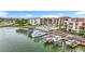 Beautiful waterfront view of condos with a community pool, dock, and well-maintained landscaping at 120 1St E St # 104, St Petersburg, FL 33715