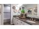 Elegant bathroom featuring dual sinks, spacious vanity and bath tub with decorative wall art at 1759 Longliner Loop, Wesley Chapel, FL 33543