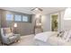 Serene bedroom with comfortable seating and an ensuite bathroom at 1759 Longliner Loop, Wesley Chapel, FL 33543