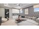 Cozy living room features custom wallpaper, modern furnishings, and a sleek entertainment area at 1759 Longliner Loop, Wesley Chapel, FL 33543