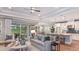 Open-concept living room with modern decor and seamless flow to the kitchen at 1759 Longliner Loop, Wesley Chapel, FL 33543