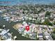 Aerial view of waterfront neighborhood with canals, lush trees, and clear skies at 1769 Brookside Blvd, Largo, FL 33770