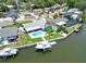 Waterfront property with a boat dock, pool, and lush landscaping, offering the ultimate in Florida living and recreational opportunities at 1769 Brookside Blvd, Largo, FL 33770