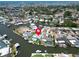 Waterfront property aerial featuring pool, boat dock, and lush landscaping at 1769 Brookside Blvd, Largo, FL 33770