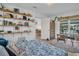 Cozy bedroom boasts wood floors, a pool view, and open shelving with stylish decorations at 1769 Brookside Blvd, Largo, FL 33770
