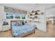 Sunlit bedroom with wood floors, an ensuite bathroom, and view of kitchen at 1769 Brookside Blvd, Largo, FL 33770
