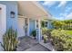 Inviting home entryway featuring decorative plants, modern lighting, and a freshly painted exterior, creating a warm welcome at 1769 Brookside Blvd, Largo, FL 33770